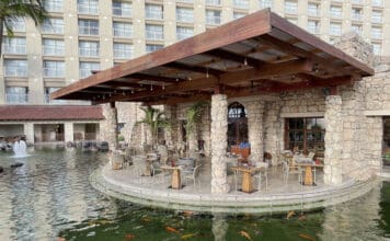 a restaurant with a pond and fish in the water