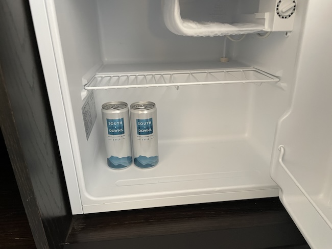 two cans in a mini fridge