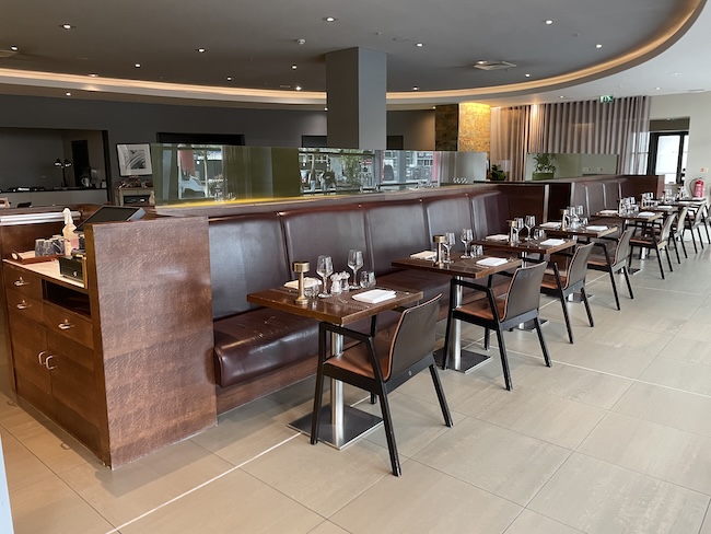 a restaurant booth with tables and chairs