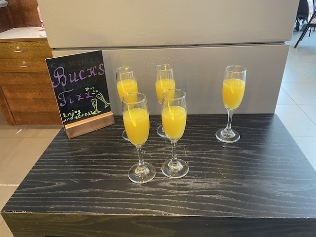 a group of glasses of orange juice on a table