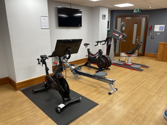 a room with exercise bikes and a monitor