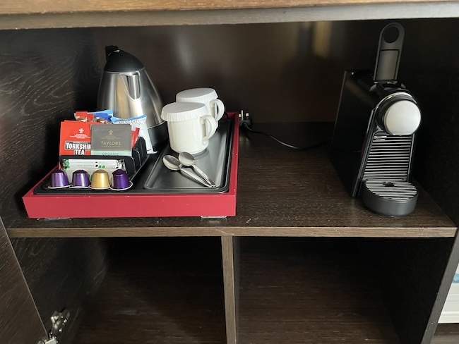 a coffee machine and coffee capsules on a shelf