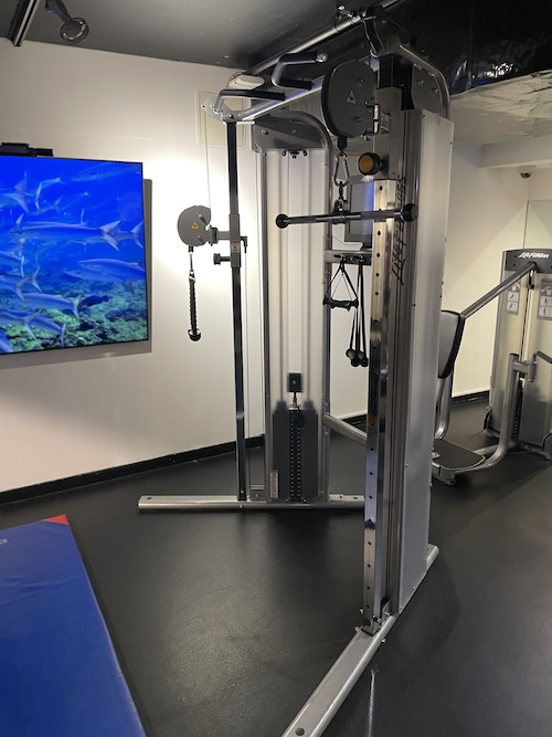 a gym with a machine and a television