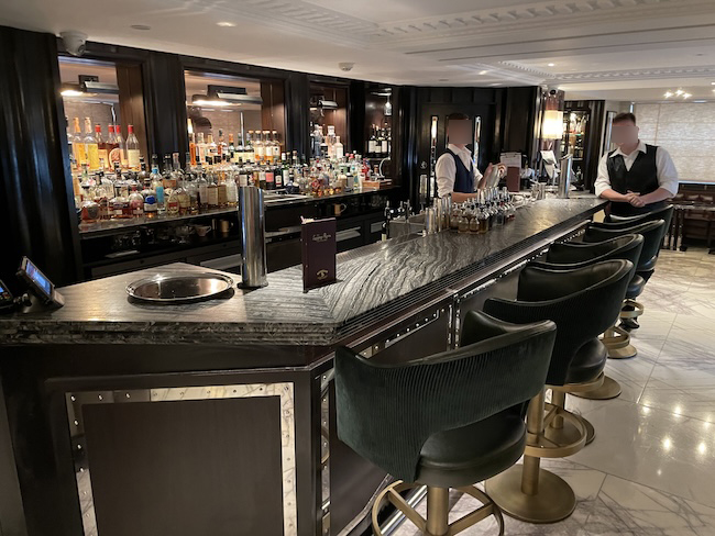 a bar with a man standing behind a bar