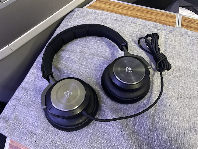 a pair of black headphones on a cloth surface