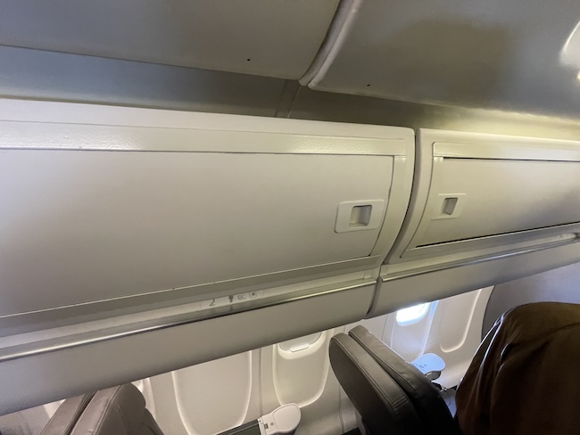 a white rectangular object with a metal bar on the side of the plane