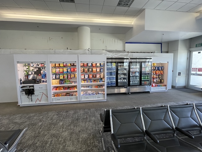 a room with a variety of snacks and a few chairs