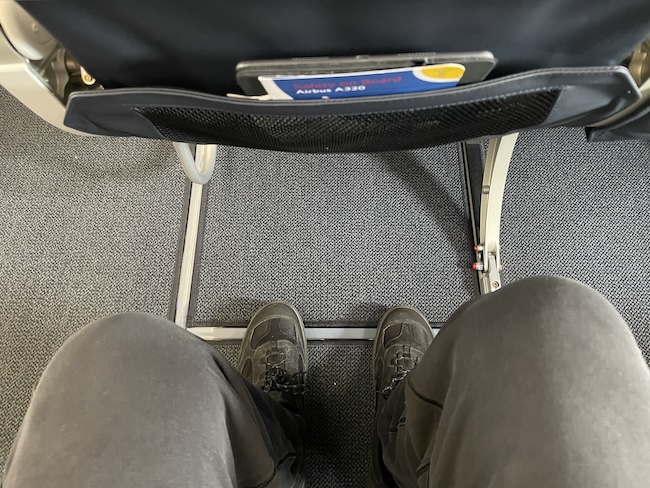 a person's legs and a seat