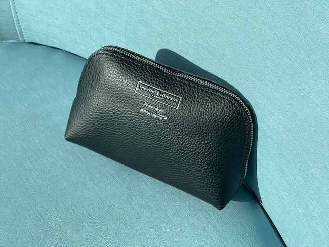 a black leather pouch on a blue surface