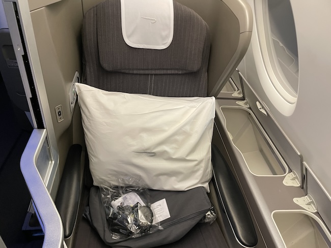 a seat with a pillow and a pillow in the middle of the seat