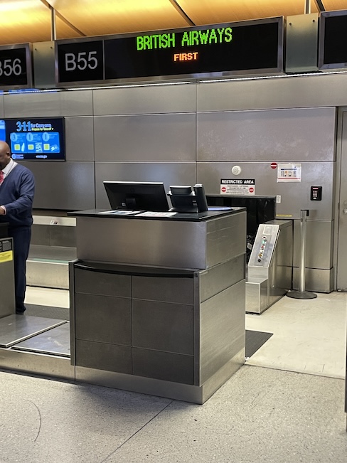 a man standing in front of a check-in counter