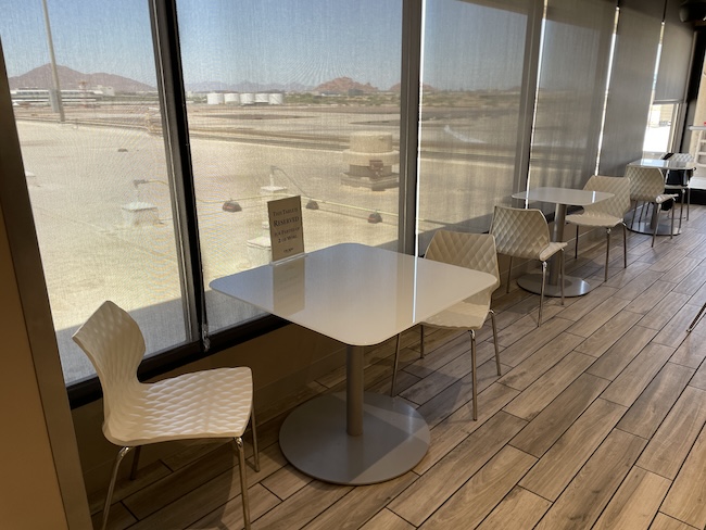 a table and chairs in a room with a window