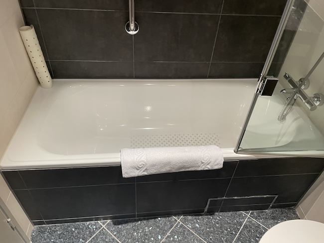 a bathtub with a towel on the side