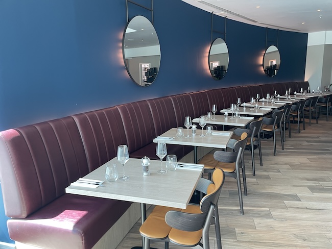 a row of tables and chairs in a restaurant