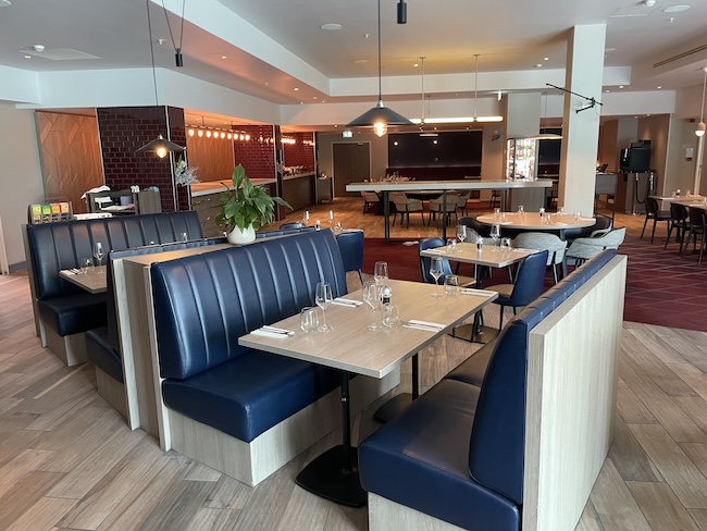 a restaurant with blue booth seating and blue seats