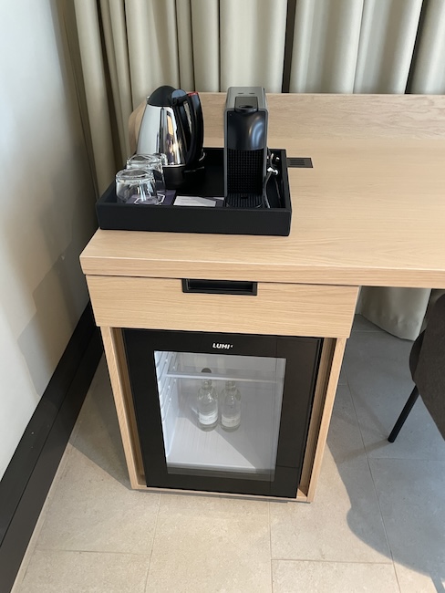 a coffee machine and a glass door on a table