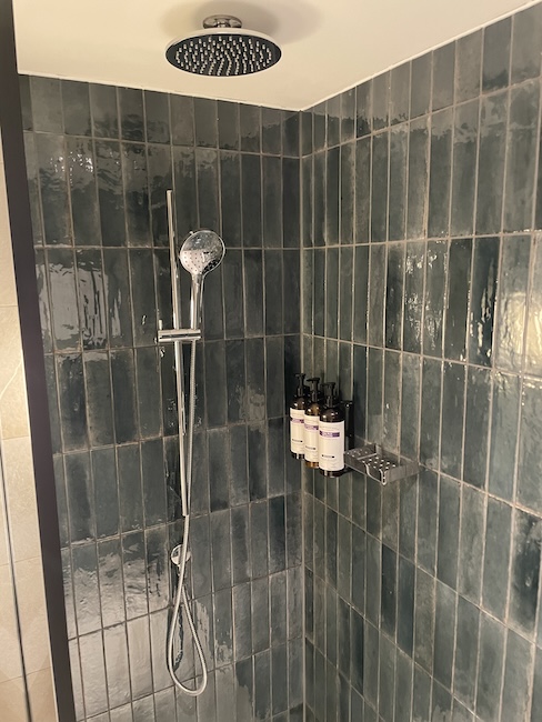 a shower with a shower head and a shower head