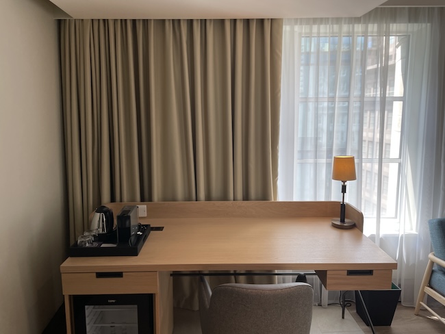 a desk in a room with curtains