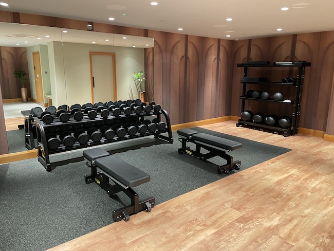 a gym with weights and a mirror