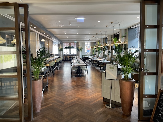 a room with tables and plants