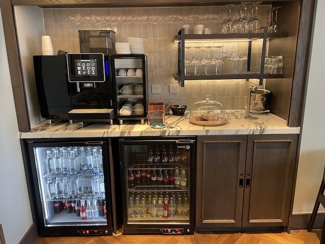 a bar with a fridge and drinks