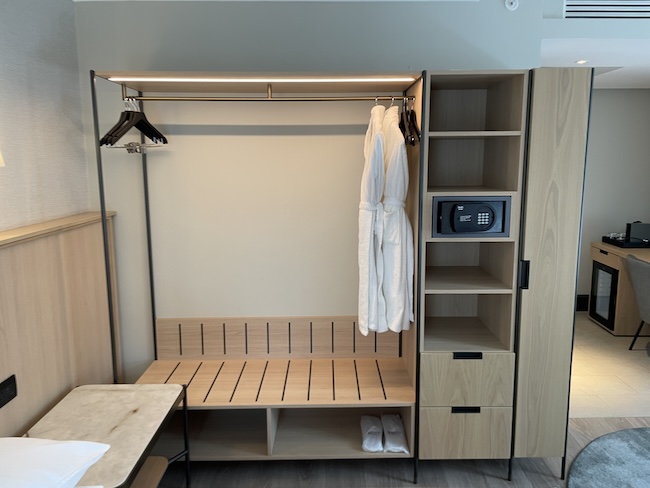 a room with a bench and a bathrobe