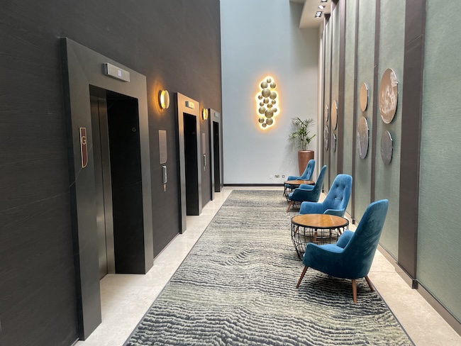 a hallway with chairs and a rug