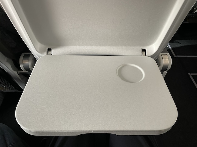 a white plastic seat with a circle in the middle