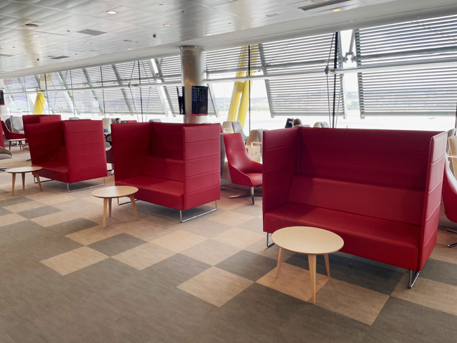 a room with red couches and tables