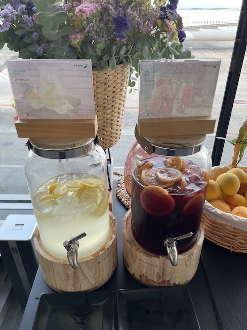 a two glass jars of liquid with a couple of fruit in a basket