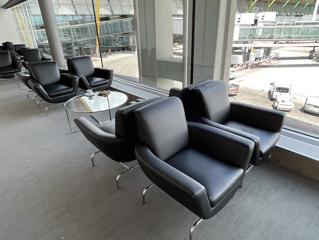 a group of black chairs in a room with windows