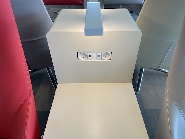 a white chair with a power outlet