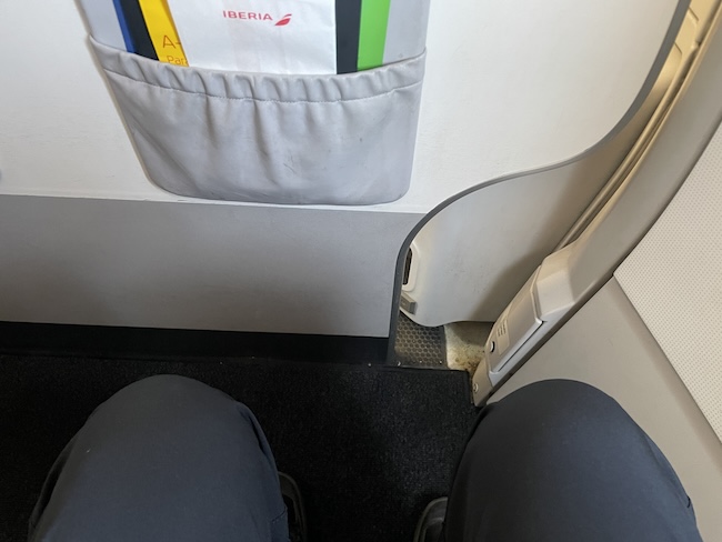 a person's legs in a pocket on a plane