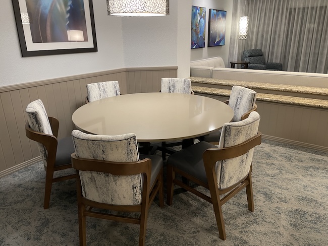 a room with a round table and chairs