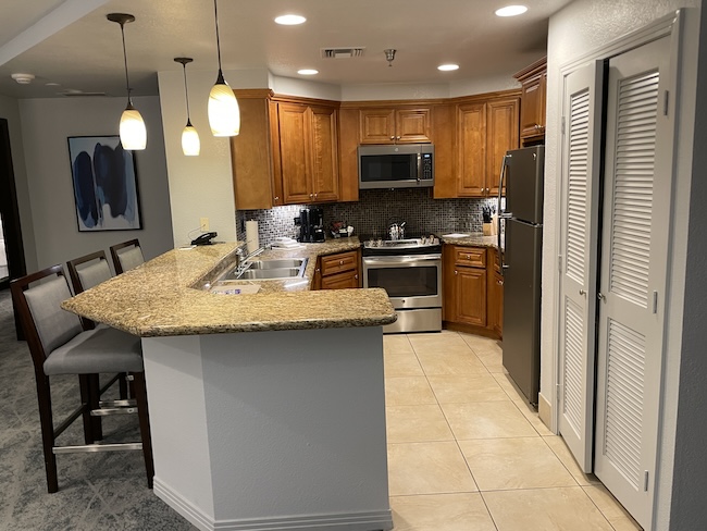 a kitchen with a bar and a stool