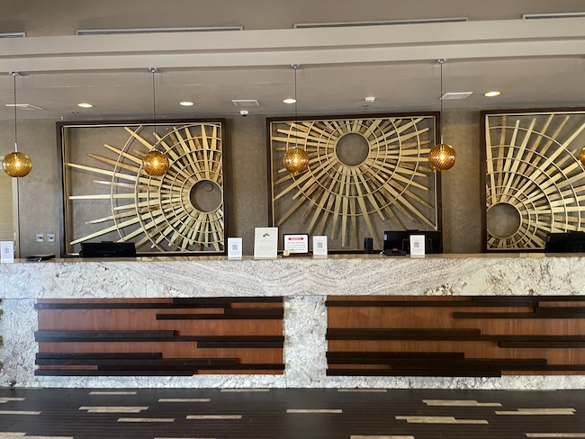 a reception desk with a few art pieces on it