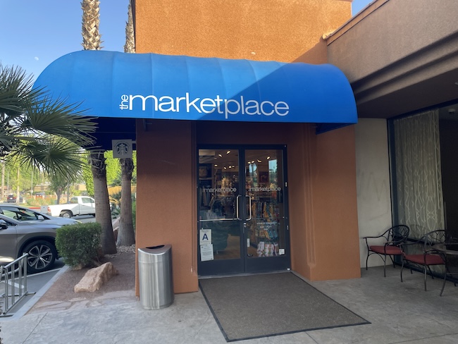 a store front with a blue awning