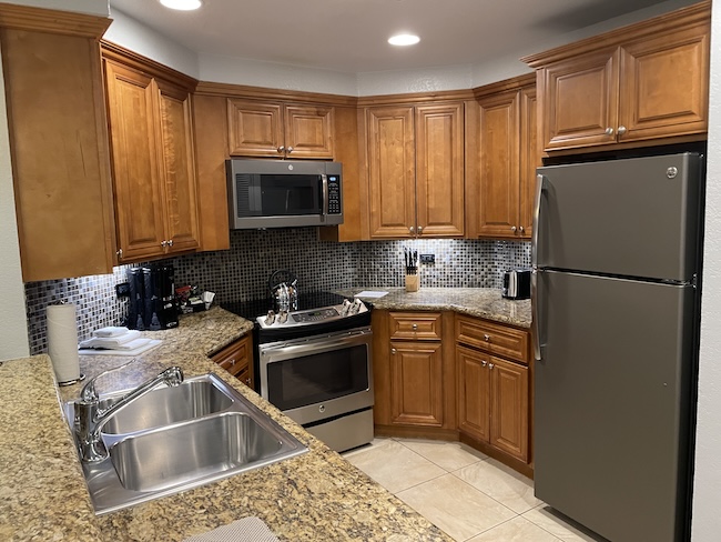 a kitchen with granite countertops and stainless steel appliances