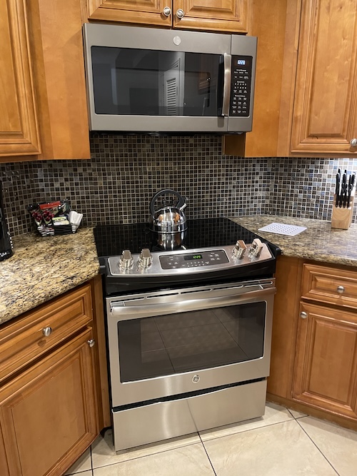 a kitchen with a stove and microwave