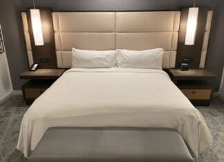 a bed with two lamps