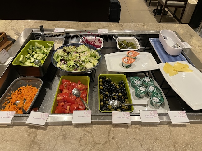 a buffet line with different food items