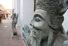 a stone statue of a man with a beard