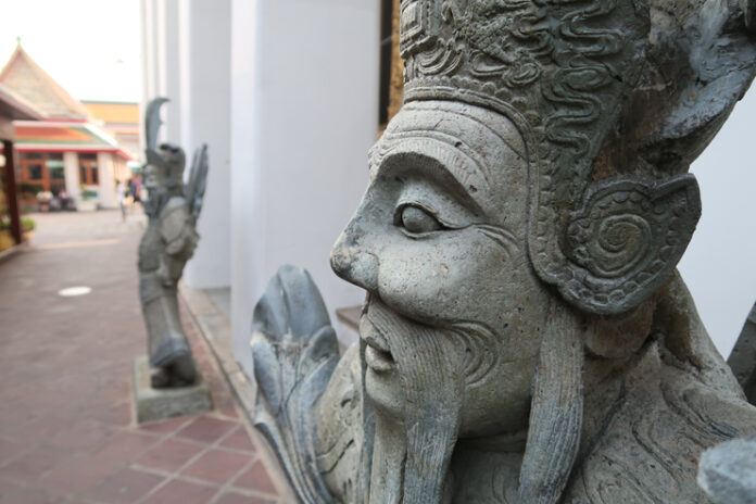 a stone statue of a man with a beard