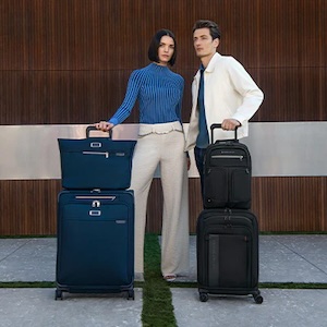 a man and woman standing next to luggage