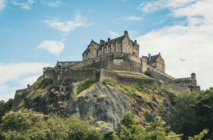 a castle on a hill with Edinburgh Castle in the background