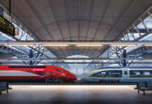 a train station with a roof and a roof