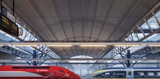 a train station with a roof and a roof