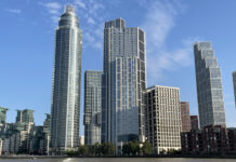 a group of tall buildings next to water