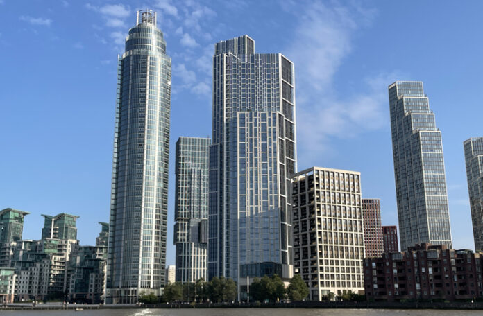 a group of tall buildings next to water