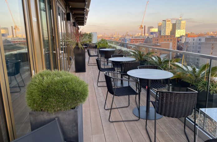 a patio with chairs and tables on a balcony